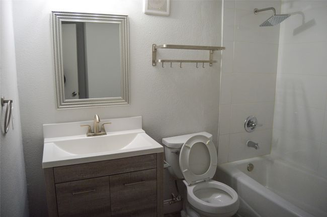 Bathroom featuring washtub / shower combination and vanity | Image 11