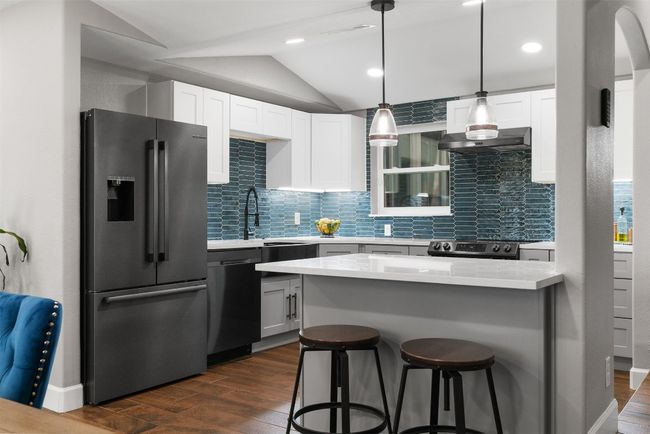 The kitchen’s custom cabinetry blends seamlessly with the rest of the home’s design, offering both beauty and practicality for all your cooking needs | Image 11
