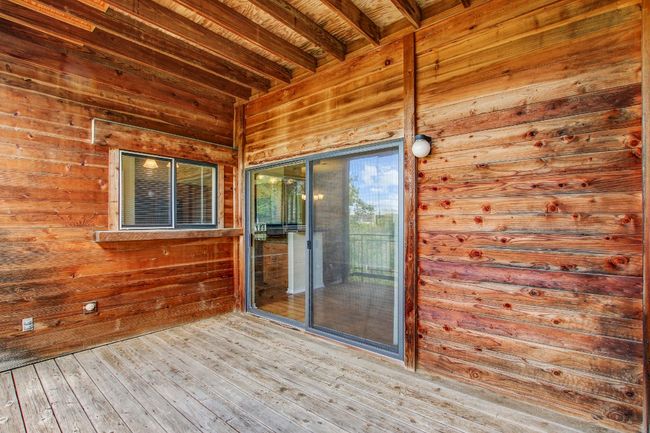 Wooden back deck with access from kitchen and a sliding glass door to the living room | Image 27
