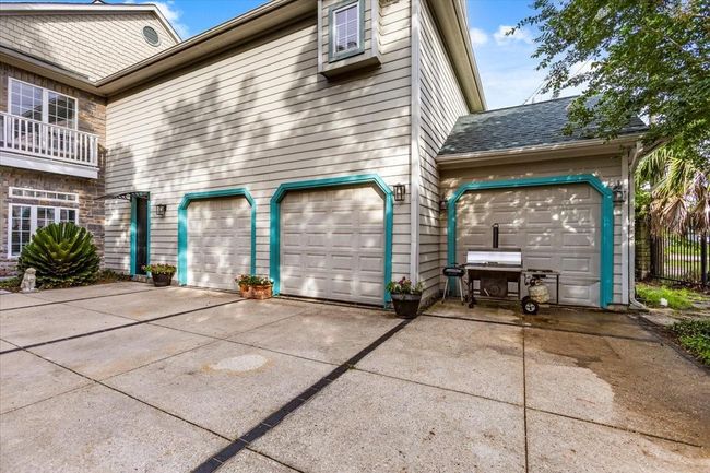 Three car garage with full guest quarters on top make for a great place to entertain friends and family. | Image 5
