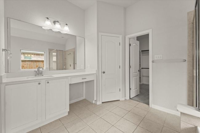 The ensuite bathroom has a large vanity and linen storage | Image 17