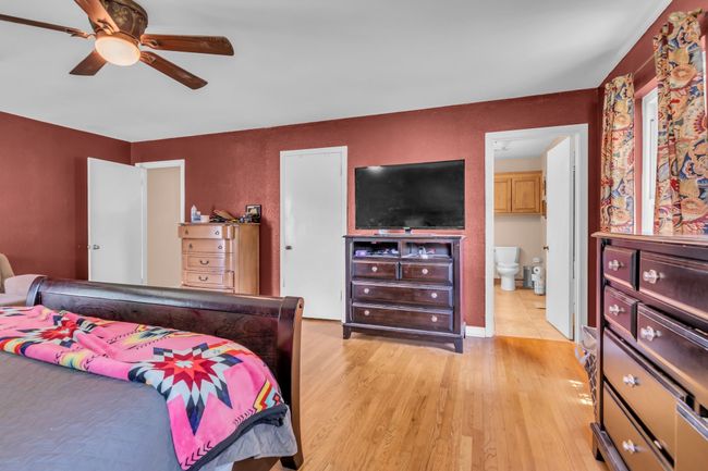 Bedroom featuring light wood-style floors, multiple windows, and ceiling fan | Image 14