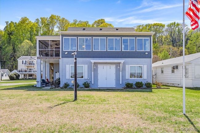 View of front of home as seen from the river - downstairs is full footprint of the upper home that has tons of storage and 2 car, drive under garage - lower patio has outdoor shower. Raised up and renovated in 2019 | Image 4