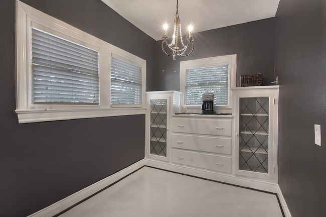 Dining room with a notable chandelier and baseboards | Image 15