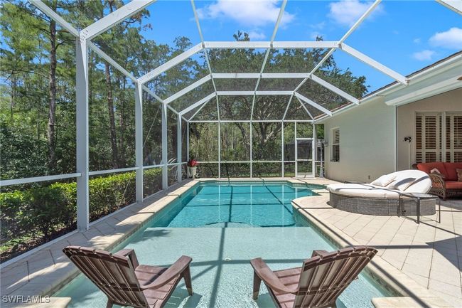 Swimming pool with a patio and glass enclosure | Image 26