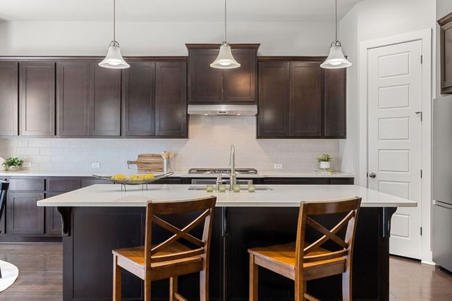 Kitchen with a large pantry and a breakfast bar. | Image 9