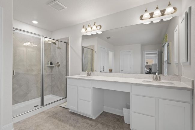 Bathroom featuring double vanity, a stall shower, and tile patterned flooring | Image 19