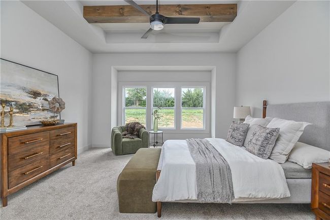 Carpeted bedroom with beam ceiling, a raised ceiling, and ceiling fan | Image 22