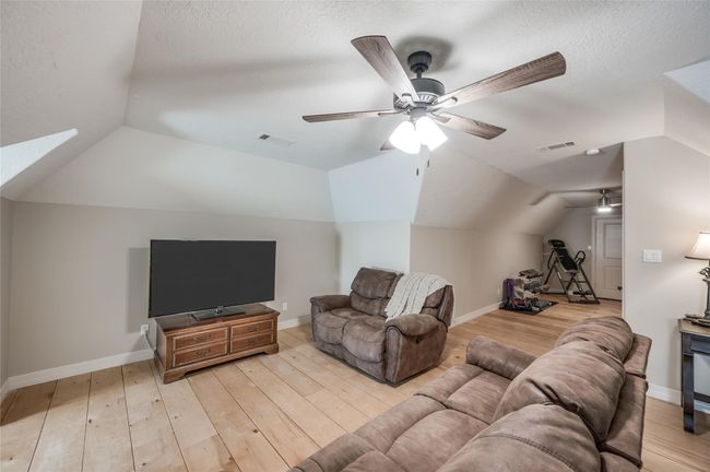 This versatile space, currently a weight room, can easily transform into a bedroom or additional living area. With the use of a few cameras, it can become a kids play room. | Image 26
