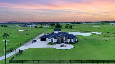 This stunning 4-bedroom, 5.5-bathroom home in Hempstead, Texas, is nestled on 5.84 acres, with 5.34 acres agriculturally exempt and .5 acres homestead exempt. | Image 2