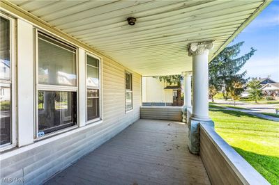 Wooden deck featuring a lawn and covered porch | Image 3