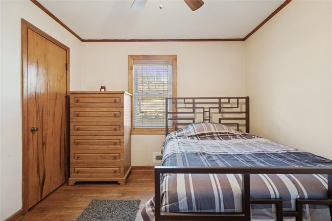 Bedroom with wood finished floors, baseboards, and ornamental molding | Image 31