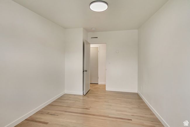 Unfurnished room with visible vents, light wood finished floors, and baseboards | Image 19