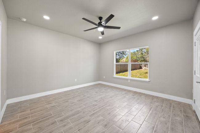 Empty room with recessed lighting, baseboards, a ceiling fan, and wood finished floors | Image 11