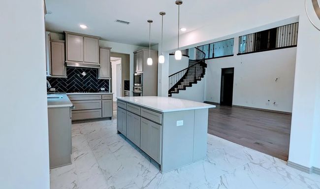 Kitchen featuring visible vents, a center island, gray cabinetry, and marble finish floor | Image 12