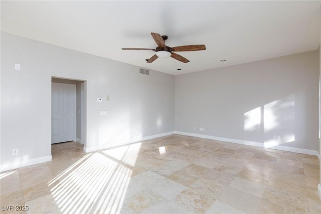 Spare room with baseboards, a ceiling fan, and visible vents | Image 9