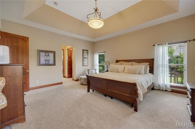 Bedroom with a raised ceiling and light carpet | Image 21