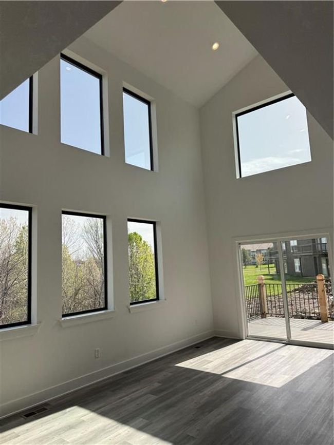 Empty room with baseboards, visible vents, wood finished floors, and recessed lighting | Image 11