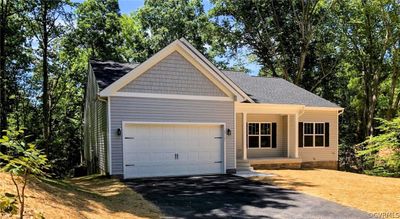 View of front facade with a garage | Image 1