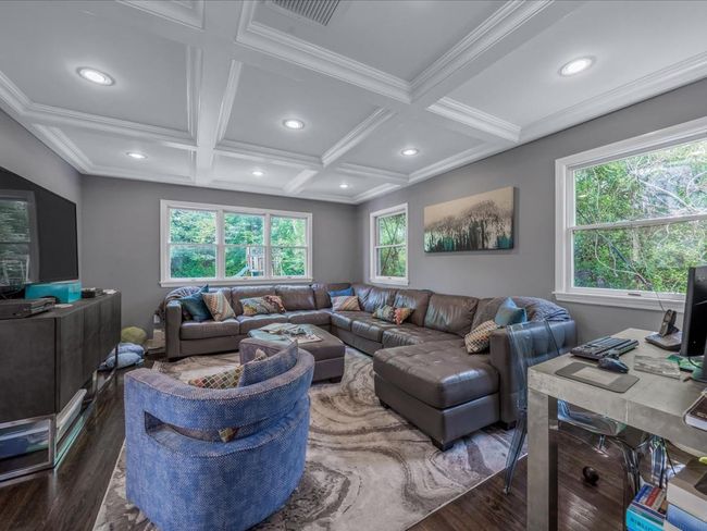 Living area with wood finished floors, coffered ceiling, plenty of natural light, recessed lighting, and beam ceiling | Image 12