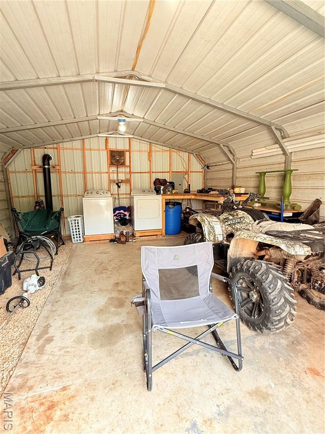 Garage with washer and clothes dryer and metal wall | Image 66
