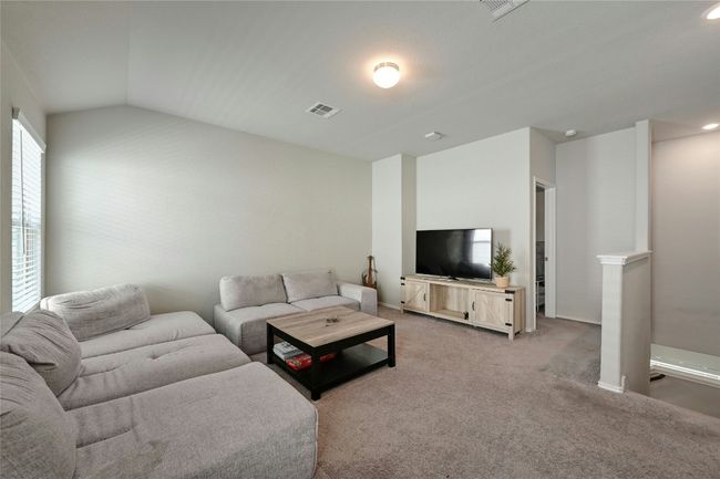 Living area featuring light colored carpet and vaulted ceiling | Image 12