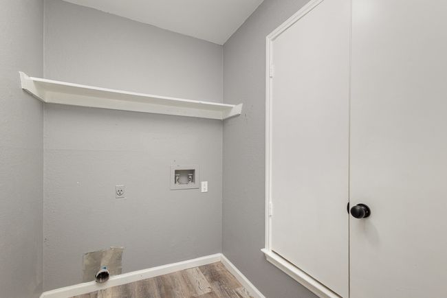 Clothes washing area featuring washer hookup, wood finished floors, electric dryer hookup, and baseboards | Image 35