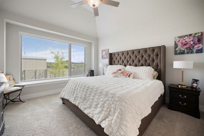 Carpeted bedroom featuring ceiling fan and a towering ceiling | Image 23
