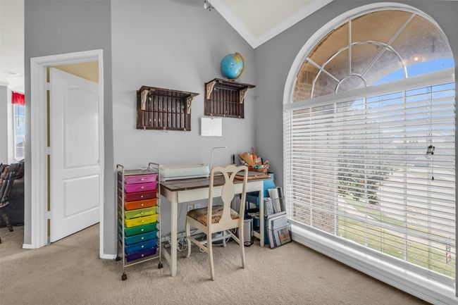 Carpeted office space with crown molding, a healthy amount of sunlight, and vaulted ceiling | Image 26