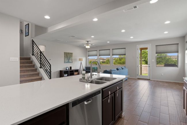 The center island is complete with gorgeous stone countertops and its breakfast bar provides additional space for enjoying your favorite meal or beverage. | Image 10