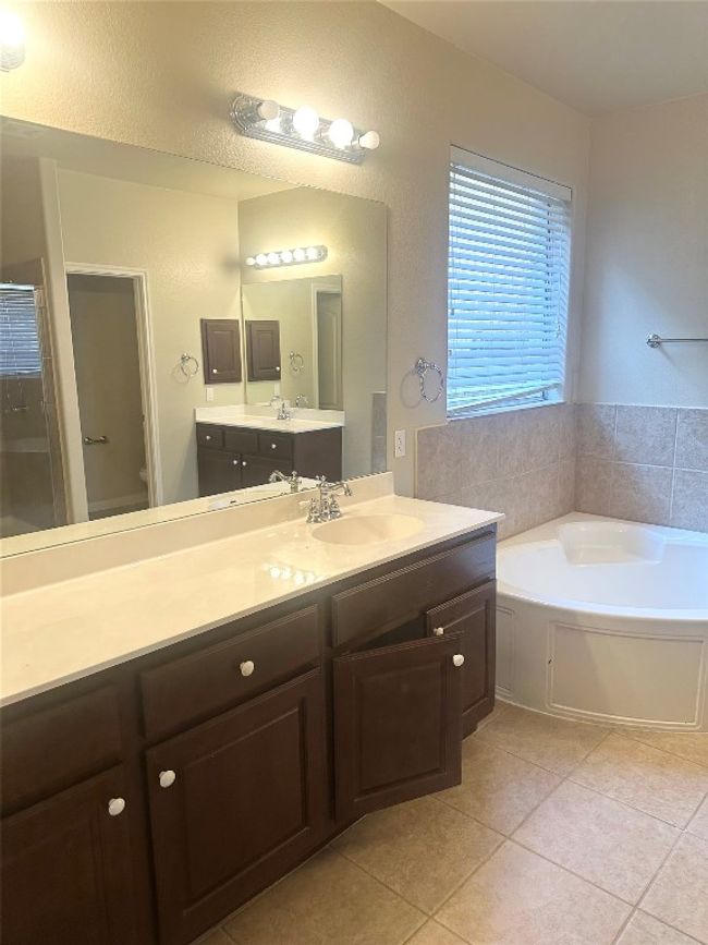 Bathroom featuring a bath, tile patterned floors, and vanity | Image 17