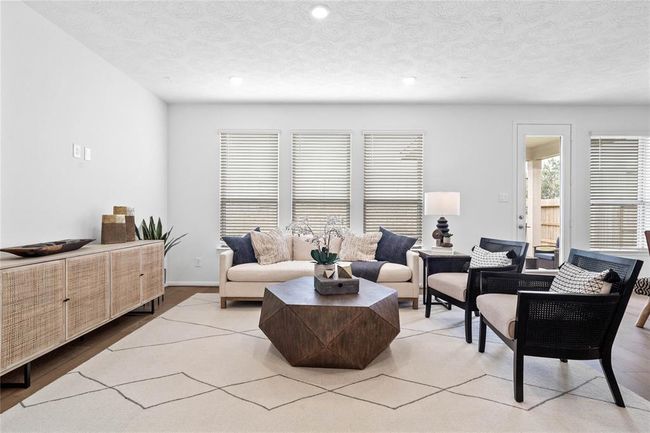This light and bright spacious family room is the perfect layout for entertaining or just relaxing. Whether it's simply a night in or entertaining family and friends, this home has ample open space for everyone to enjoy! Featuring engineered wood flooring, large windows with privacy blinds, high ceilings, recessed lighting with wonderful access to your gorgeous kitchen. | Image 14