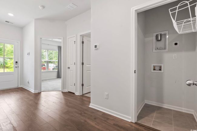 Laundry room with electric dryer hookup, washer hookup, and dark wood-style floors | Image 10