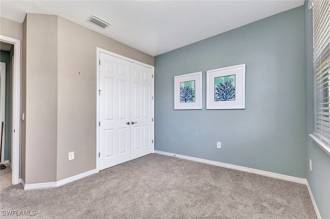 Unfurnished bedroom with carpet, visible vents, a closet, and baseboards | Image 16