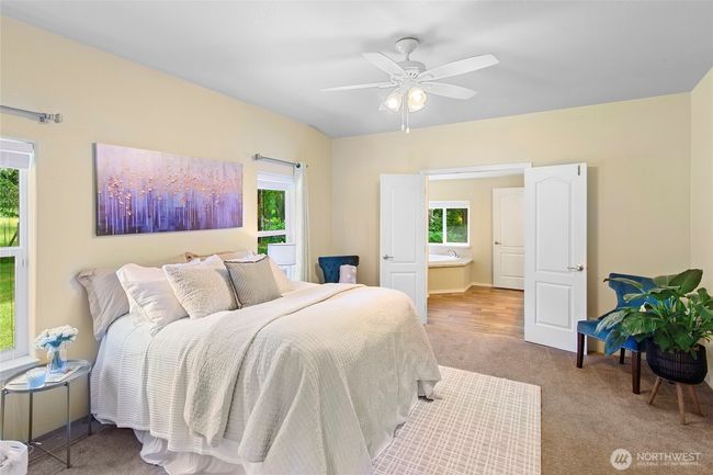 Primary bedroom with the primary bath in the background. | Image 16