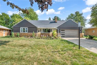 Ranch-style home with a garage and a front lawn | Image 2