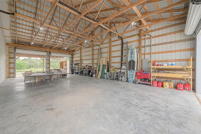 Massive garage with four roll up doors, two in the front and two in the back. | Image 23