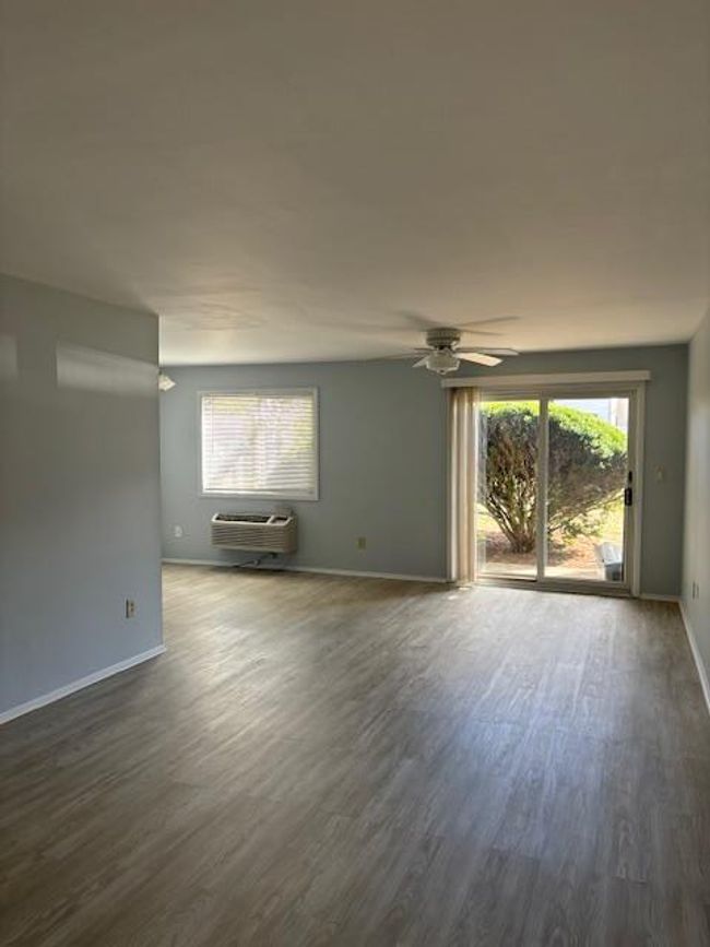 living room with ceiling fan, and slider to patio | Image 5