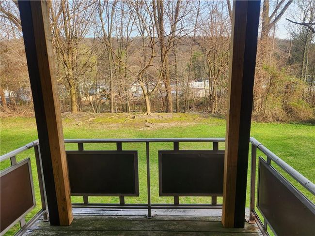 Private deck overlooking a grassy area with trees | Image 13