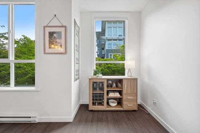Doorway to outside with dark wood finished floors, a baseboard heating unit, and healthy amount of natural light | Image 20