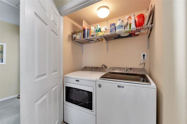 Centrally located on the second floor, this laundry nook offers easy access to all bedrooms with built-in shelving to keep everything organized and within reach. | Image 17
