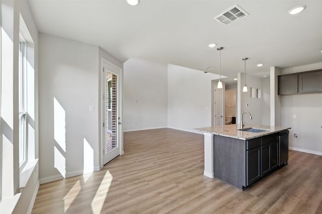 Kitchen with light wood-type flooring, recessed lighting, dishwashing machine, and plenty of natural light | Image 8
