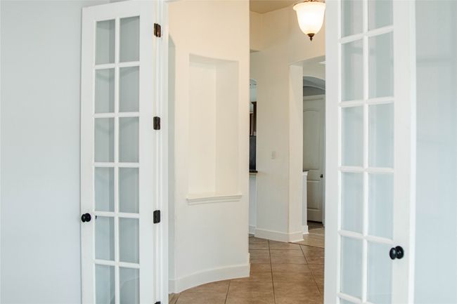 Hallway with arched walkways and tile patterned flooring | Image 18