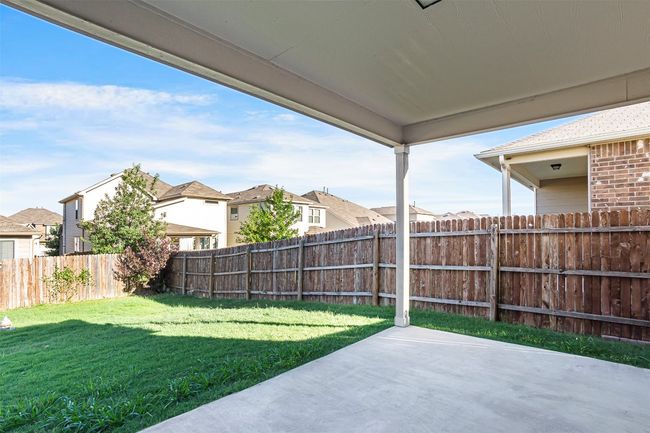 Fenced backyard with a patio area and a residential view | Image 35