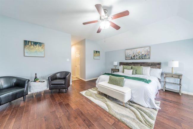 Bedroom featuring lofted ceiling, hardwood / wood-style flooring, and ceiling fan | Image 21