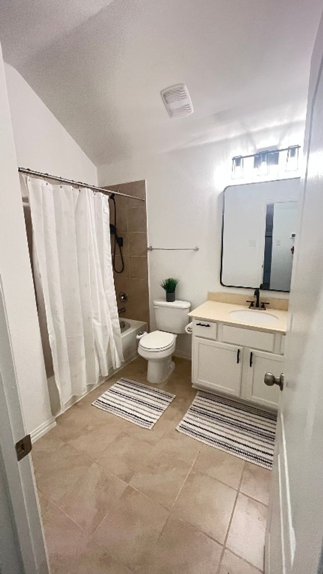 Bathroom 3 featuring toilet, shower / bath combination with curtain, vanity, and tile patterned floors | Image 26