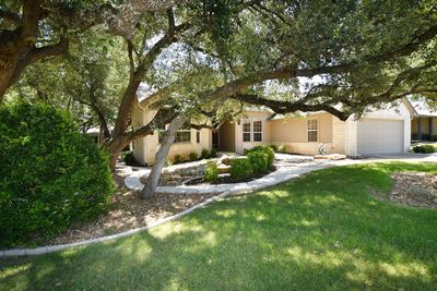 Native oaks and stone edging create a pleasing curb appeal at this Trinity plan. | Image 1