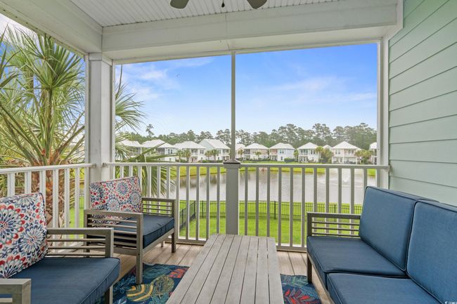 Screened in upper deck off of the dining area featuring a water view. | Image 28