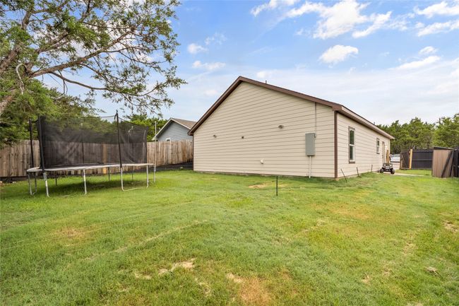 View of yard featuring a trampoline | Image 35
