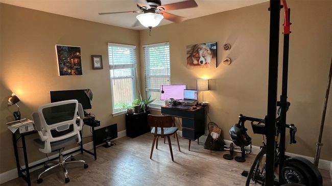 Office space with plenty of natural light, ceiling fan, and wood finished floors | Image 18